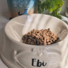 veraPaws Collagen For Dogs powder sprinkled over a bowl of kibble. 