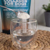 Premium Collagen For Dogs powder sprinkled into water. It is then stirred and we get a clear look from on top to show a clear liquid solution.